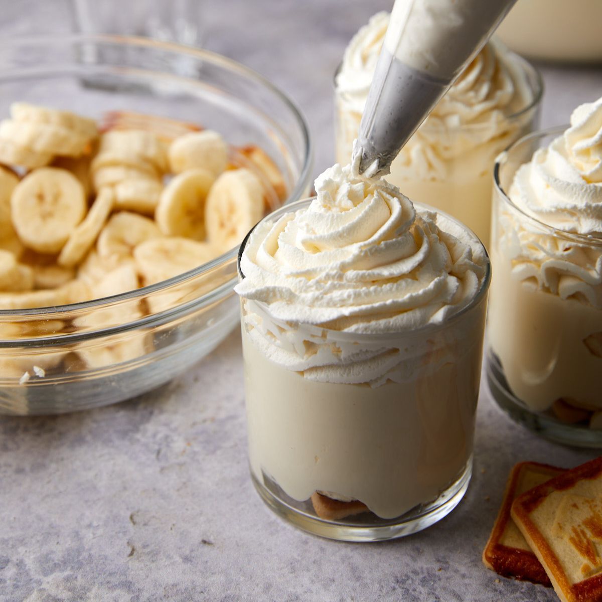 Whipped cream piped on top of homemade banana pudding cups.