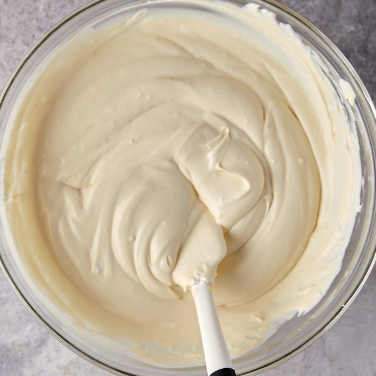 Whipped cream being folded into the banana pudding filling.