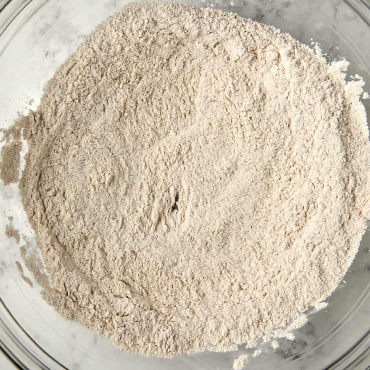 Whisked dry ingredients with apple pie spice for apple cider loaf cake.