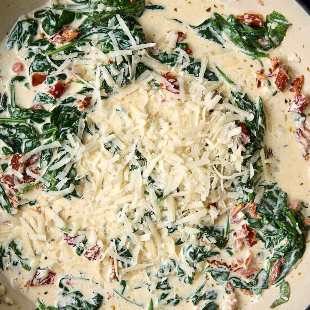 Wilted spinach stirred through the cream sauce with grated parmesan scattered over the top.