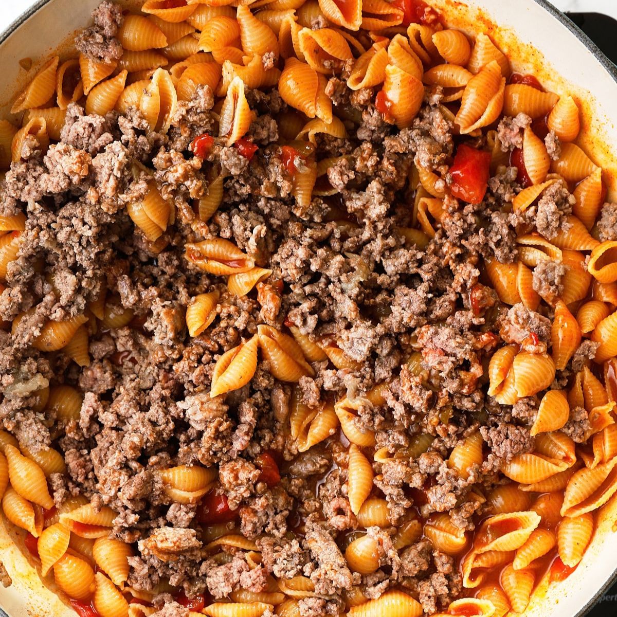 Browned ground beef stirred back into the cooked pasta shells.
