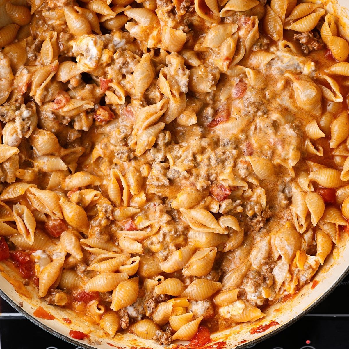 Finished one-pot taco pasta with sour cream and melted cheddar stirred into a creamy sauce.